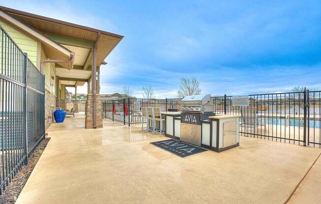 the spacious patio is fenced in with a pool and a fence