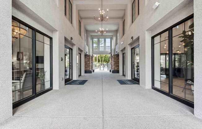 A long hallway with a white floor and white walls with black trim. at The Laurel Apartments, Chandler, AZ 85286