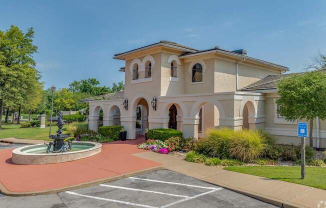 A building with a fountain in front of it.
