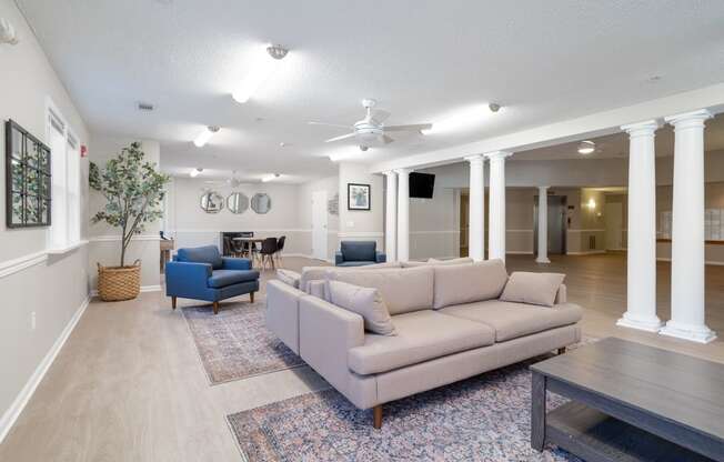 a living room with couches chairs and a coffee table