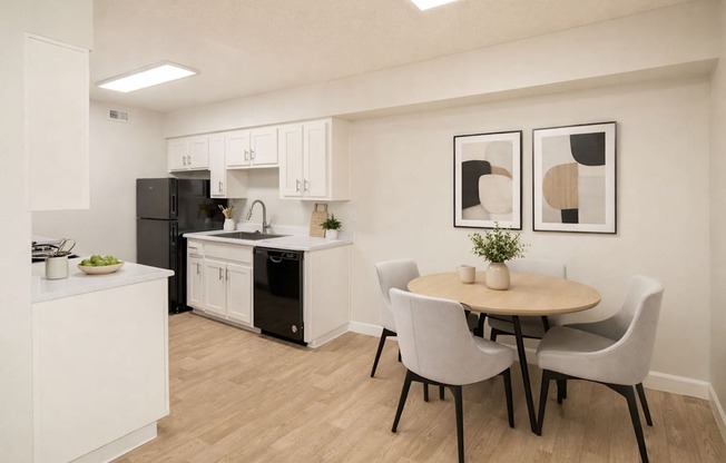 A kitchen with a table and chairs.