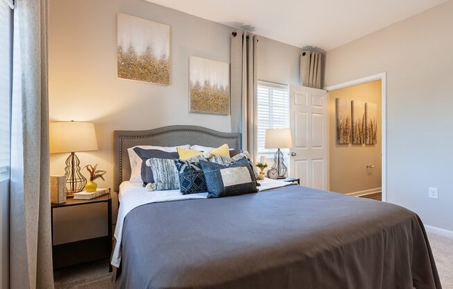 Spacious bedroom with natural lighting and plush carpeting at The Summit on 401