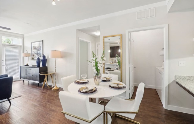 a living room and dining room with a table and chairs