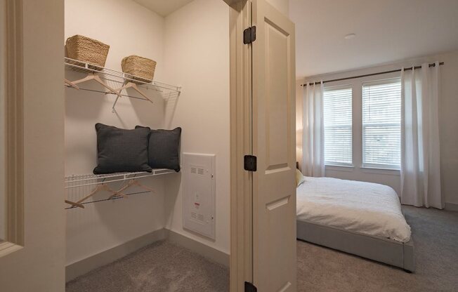 a bedroom with a bed and a white closet