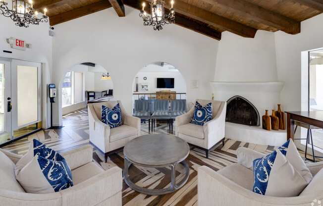 a living room with couches and a table and a fireplace