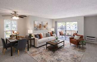 A living room with a dining table set up with chairs around it.