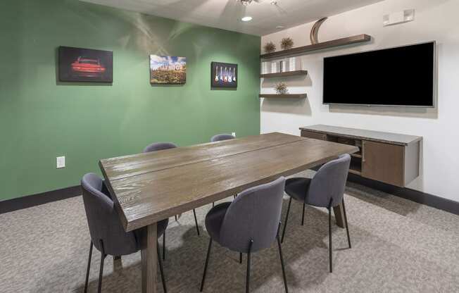 a conference room with a long table and a television at The Hendrix, Atlanta, Georgia