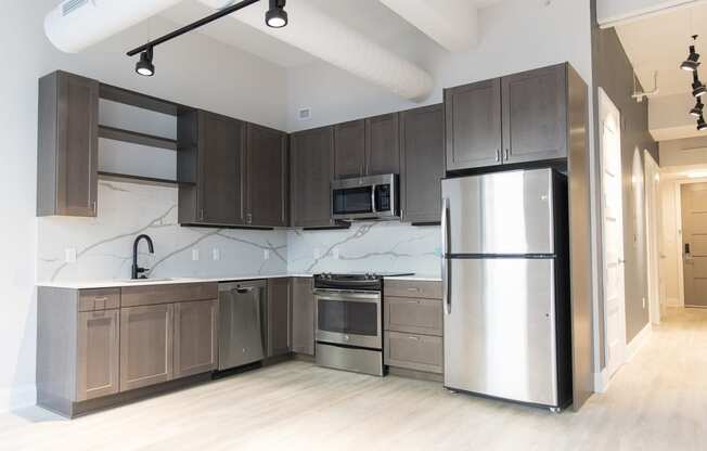Kitchen with hardwood floors and stainless steel appliances at 35W in Detroit. MI