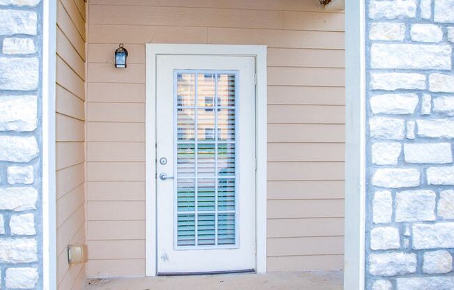 the entrance to a home with a white door