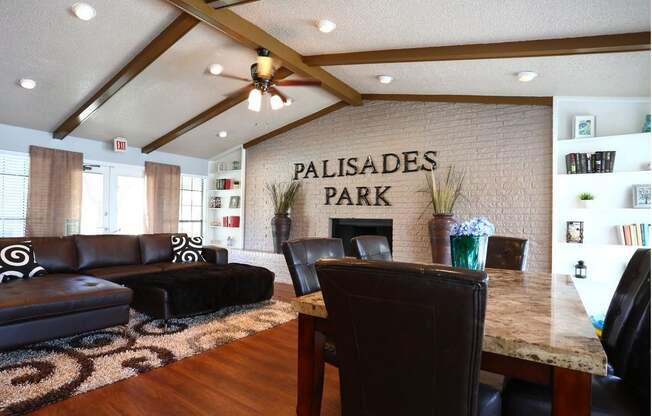 a community room with a table and leather furniture