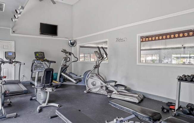a home gym with treadmills and exercise bikes