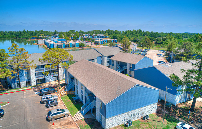 an aerial view of a building with a lake in the background