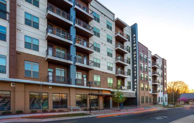 picture of an apartment building with a street in front of it