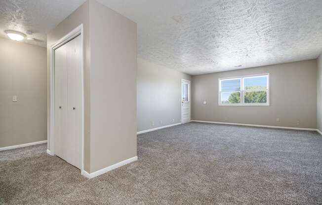 Omaha, NE Maple Ridge Apartment. A bedroom with carpet and a door to a bathroom