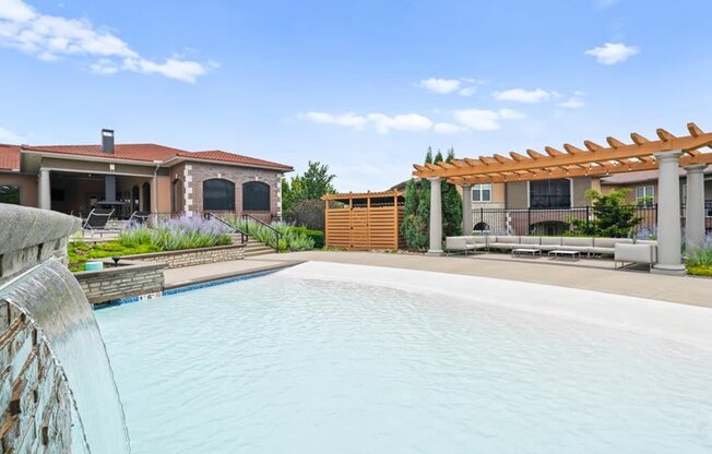 a large swimming pool in front of a house