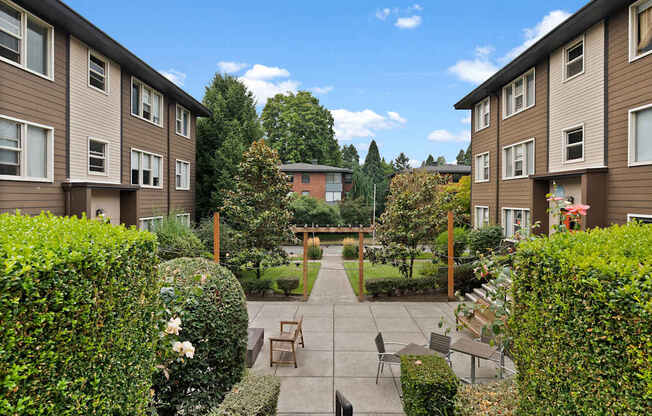 A sunny day at a residential area with apartment buildings and a garden.