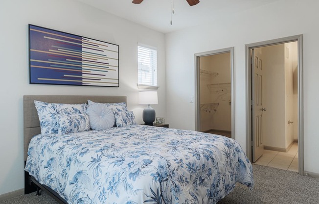 a blue and white bedroom with a bed and a closet