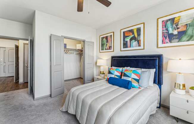 a bedroom with a large white bed and a ceiling fan