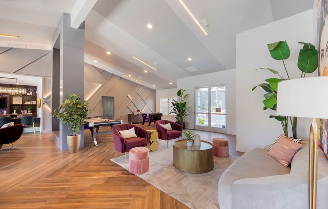 a living room with furniture and a pool table at Paisley and Pointe Apartments, Nevada