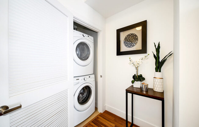 a white washer and dryer in a room with a door