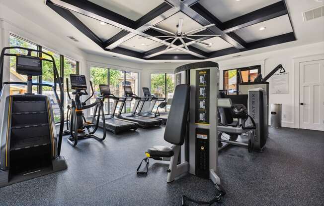 a large exercise room with treadmills and other fitness equipment