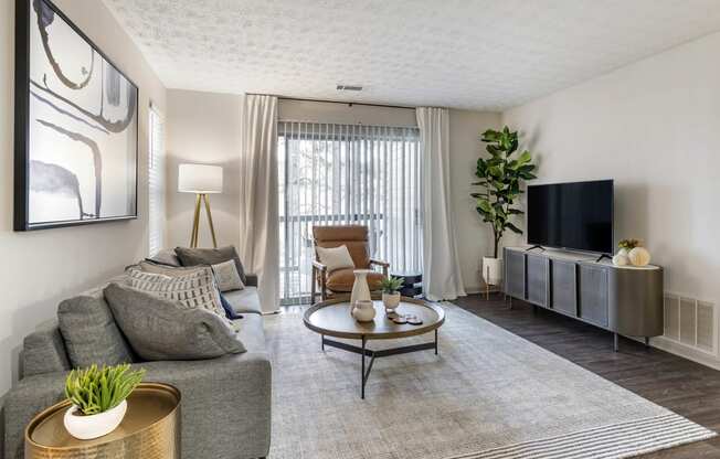 a living room with a couch and a tv at Gwinnett Pointe, Georgia, 30093