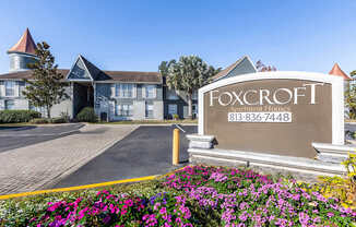 The entrance to the Foxcroft Apartment Homes with a sign displaying the phone number 813-836-7448.