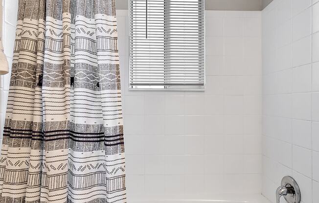 a bathroom with a bath tub and a shower curtain