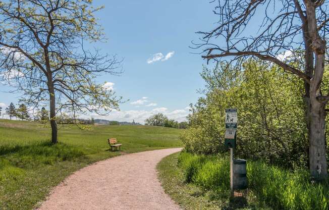 Gravel Hiking Trail with Bench, Trees Alongside