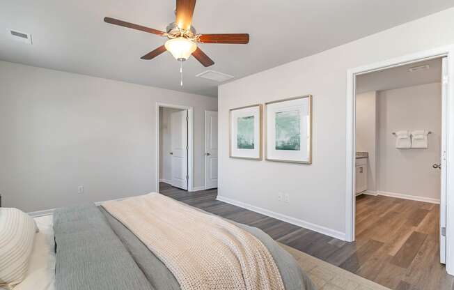 a bedroom with a large bed and a ceiling fan