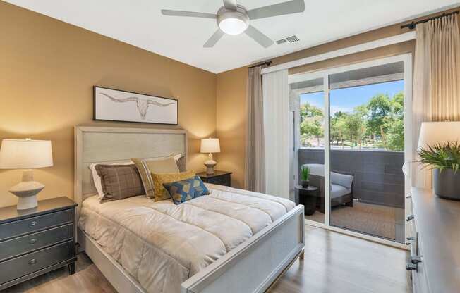 a bedroom with a bed and a ceiling fanat Weylyn Luxury Apartments, Laveen, AZ 85339