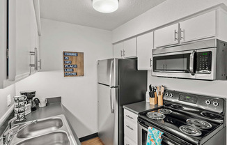 our modern kitchen has stainless steel appliances and a stainless steel sink