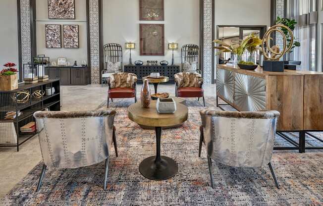 A living room with a round table and chairs.