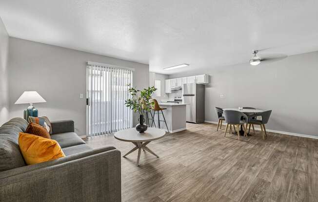 A living room with a grey couch and a coffee table.