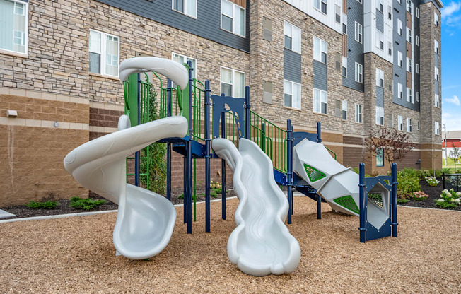 A playground with a slide and a climbing frame.
