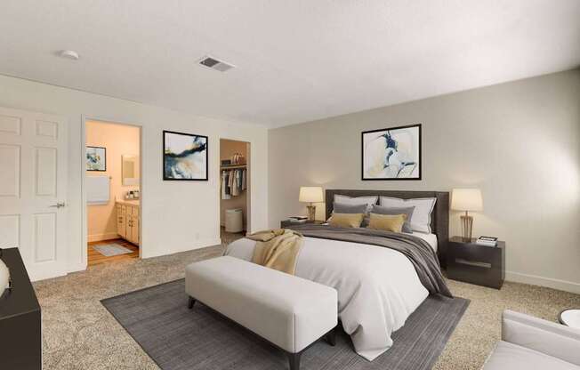 A bedroom with a large bed and a painting on the wall.