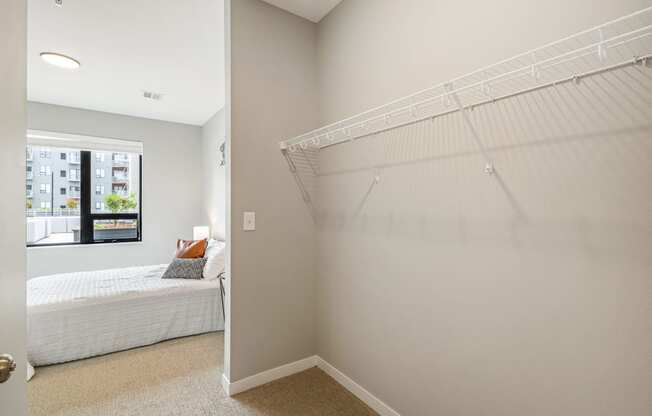 a closet in a bedroom with a bed and a window at EagleRidge Plaza Residences, North Dakota