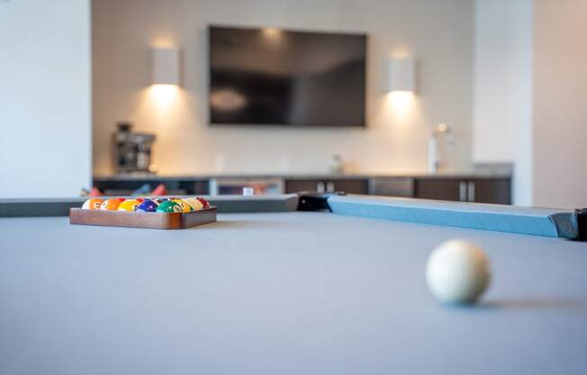 a pool table in a living room with a tv at 20 Midtown, Birmingham, 35233