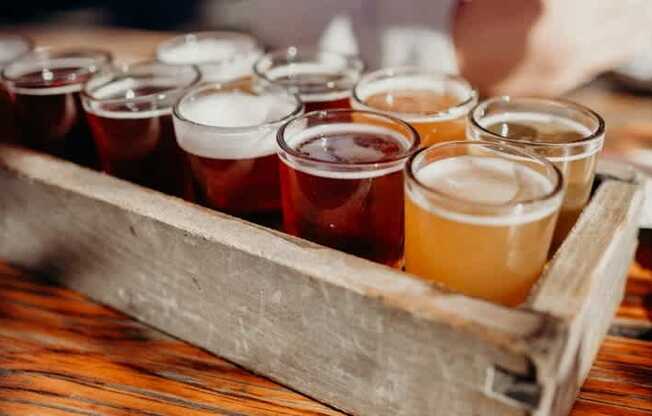 a wooden box filled with different types of beers