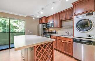 Kitchen, Wine Rack, Laundry Machine and Dishwasher at Whispering Brook Apartments, Des Moines, WA