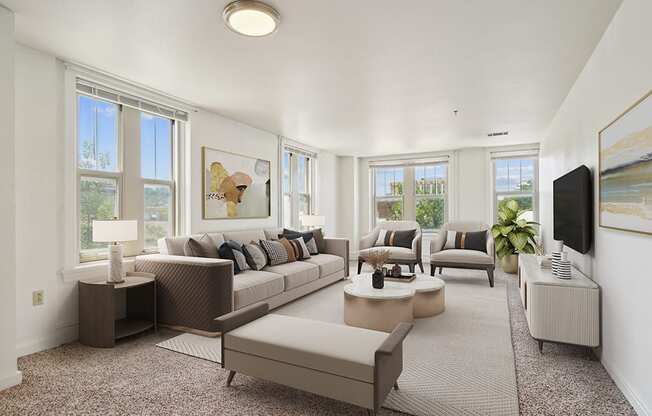 the living room of an apartment with couches and chairs