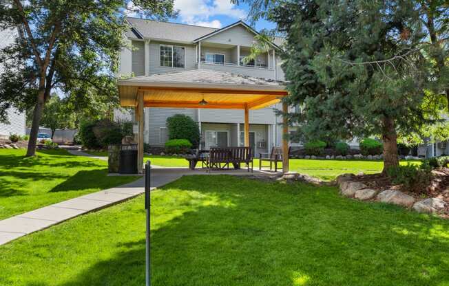 a covered patio in front of a house