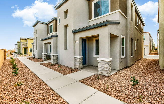 a street view of a house with a sidewalk and landscaping