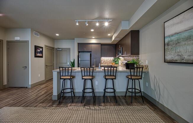 Spacious bar seating opens to an open‑concept kitchen, creating an inviting spot for casual dining.
