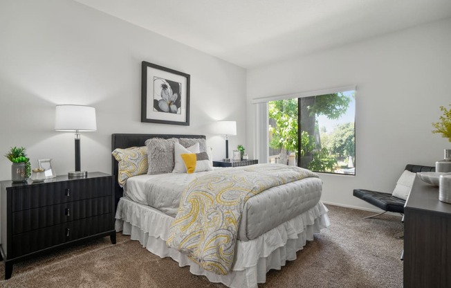 a bedroom with a large bed and a large window