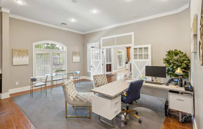 a home office with a white desk and chairs