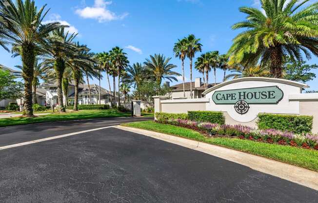 A street view of Cape House with palm trees on the side.