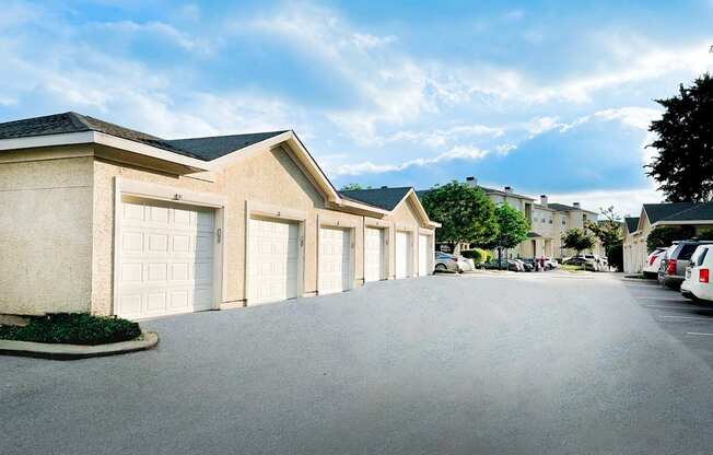 A row of houses with garages on the side.