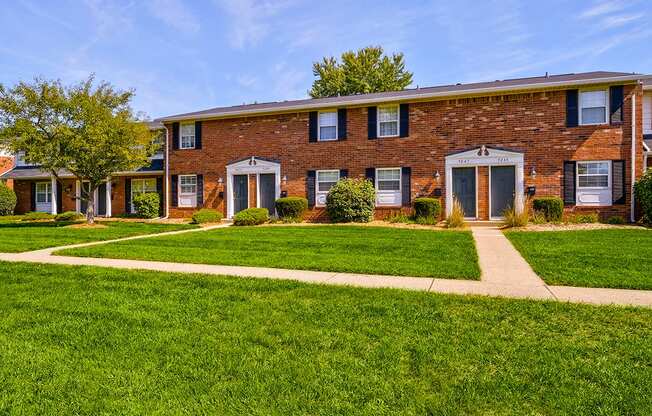 Exterior view of Ashton Brook Apartments, showcasing the building's architecture and surrounding landscaping.
