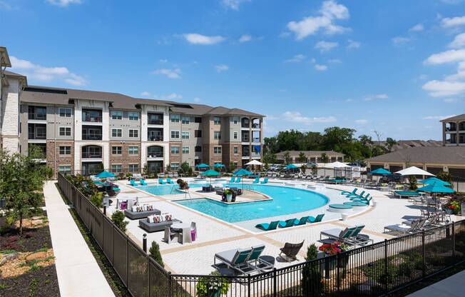 Salt-water swimming pool with sundeck and cabanas at Cyan Craig Ranch apartments for rent